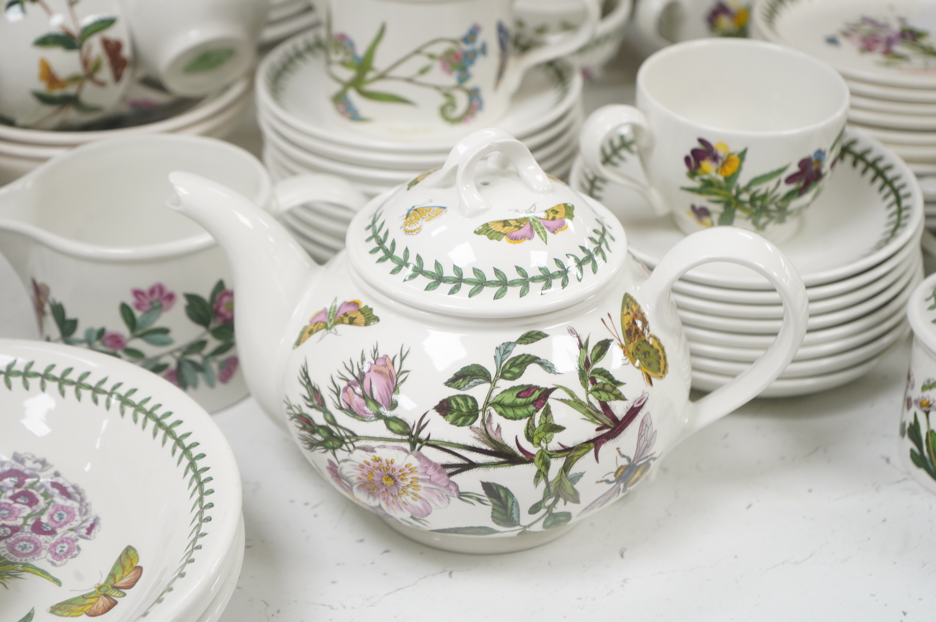 A large quantity of Portmerion Botanic Garden dinner and tea wares to include graduated bowls, dinner plates and side plates